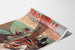 Vintage Normandy – Trouville municipal casino poster, shown on a curled sheet in perspective.