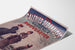 Vintage reclameposter Galeries sedanaises, Nouveautés, gepresenteerd op een licht gekromde pagina in perspectief.