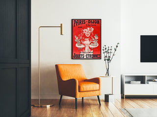 Vintage advertising poster Paris–Dijon, toys and holiday gifts, framed in a living room with an orange armchair and a floor lamp.