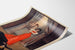 Vintage poster How London Lives, Surrey Theatre, displayed on a curved sheet, perspective view.