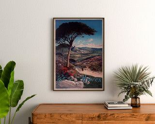 Vintage poster Hyères, ingelijst boven een houten dressoir, tussen planten.