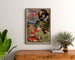 Vintage Laiterie de l’Isle Briant, Angers poster, framed above a wooden chest of drawers, between plants.