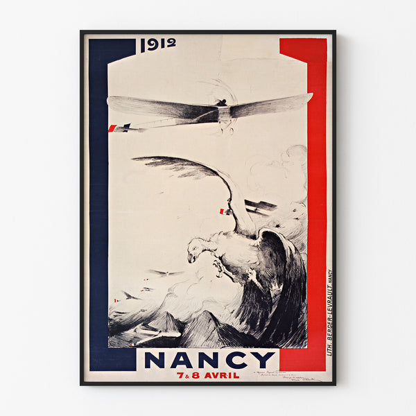 Vintage affiche Nancy, luchtvaartmeeting, weergegeven in een dunne lijst aan een lichte muur.