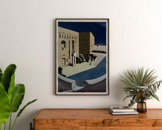 Vintage Orange poster, Roman theatre PLM, framed above a wooden dresser, between plants.