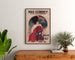 Vintage Paris–Clermont winter season poster, framed above a wooden dresser, between plants.