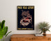 Vintage poster Lefort bicycle tires, framed above a wooden dresser between plants.